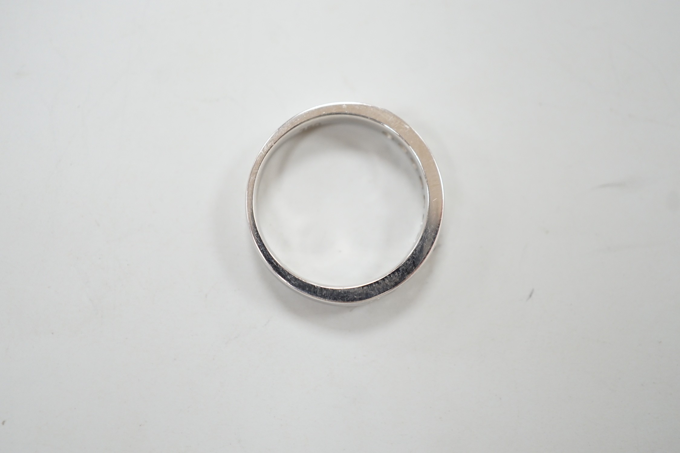 A modern 18k white metal and ten stone channel set diamond half eternity ring, size L/M, gross weight 4.1 grams.